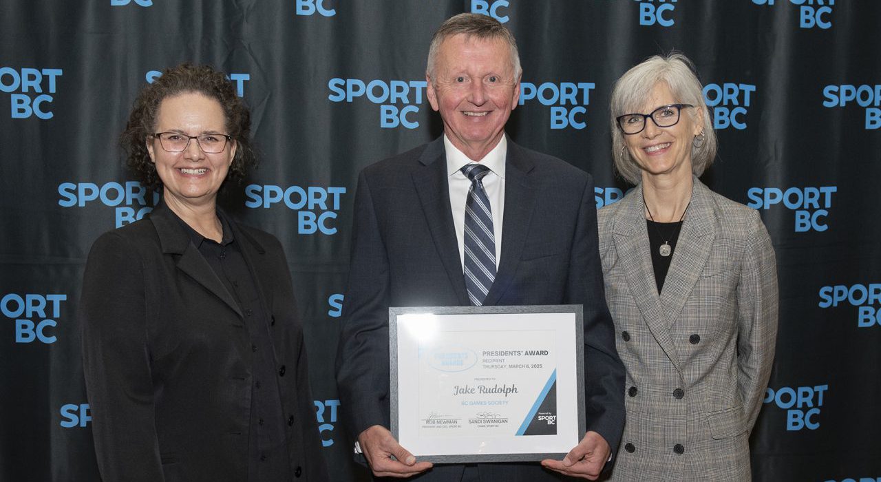 Jake Rudolph accepts the President's Award alongside BC Games Society President and CEO Alison Noble.